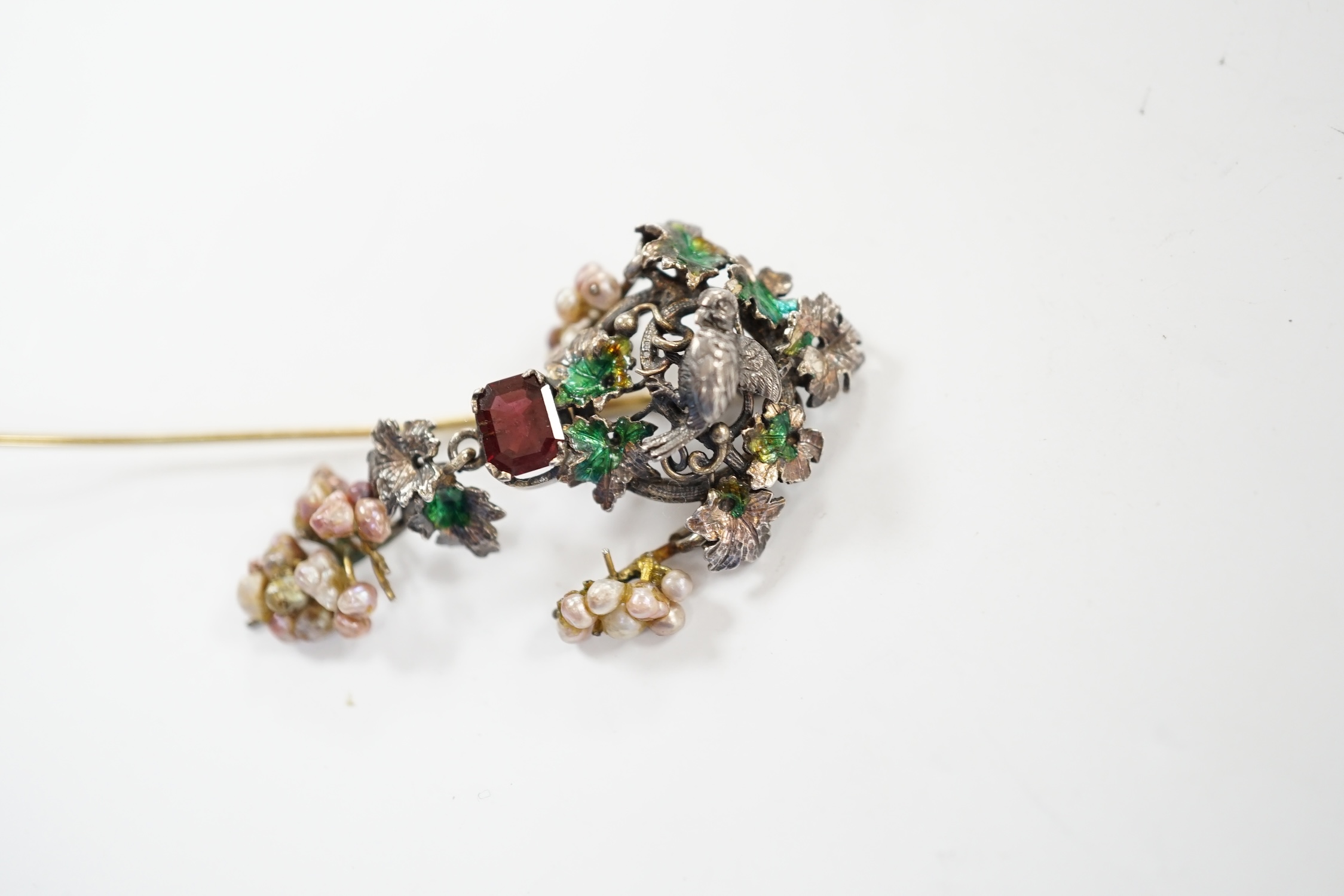 A 19th century Austro-Hungarian white metal garnet, enamel and seed baroque pearl set stick pin (adapted), 84mm.